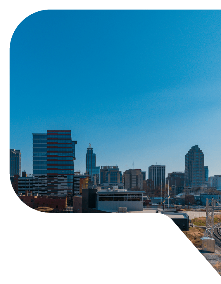 View of Raleigh, North Carolina skyline under a clear blue sky.