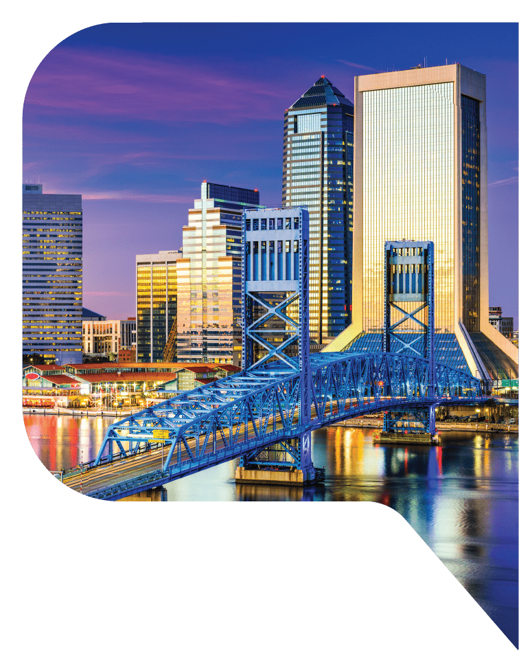 A blue bridge across the river in front of the city of Jacksonville, Florida.