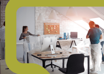 People preparing to move to a new office as they wrap up computers and more.